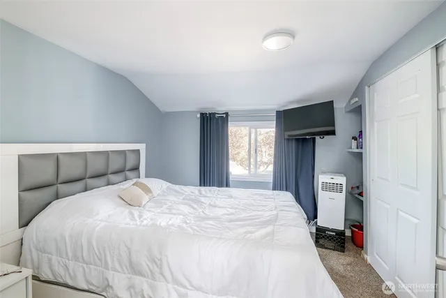 a bedroom with a bed and a window