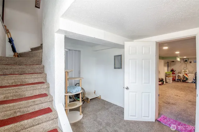 a view of a hallway view with staircase and living room