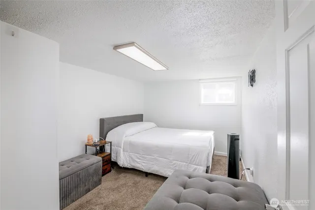 a bedroom with a bed and a couch