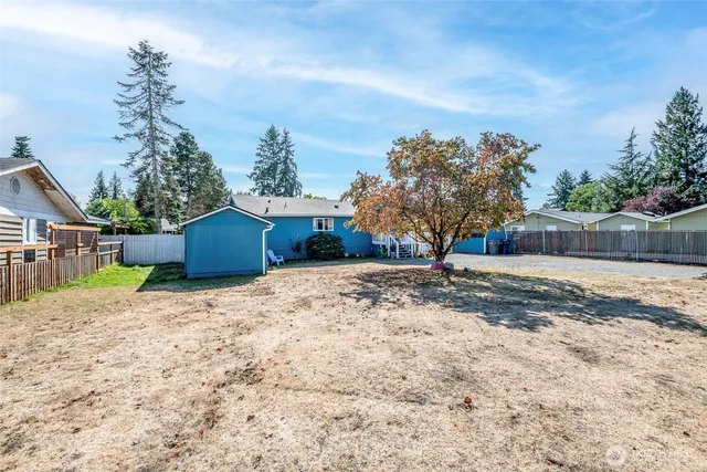a wooden fence with some trees in the background