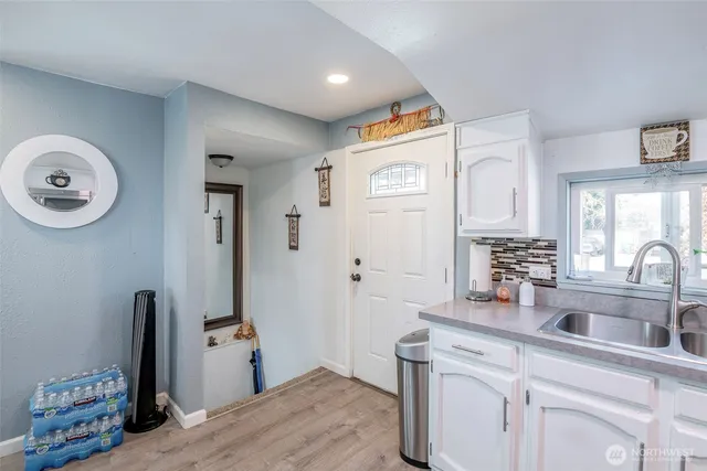 a kitchen with a sink cabinets and appliances