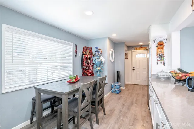 a view of a dining room with furniture and wooden floor