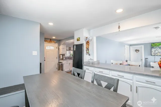 a large kitchen with stainless steel appliances a large counter top and a stove