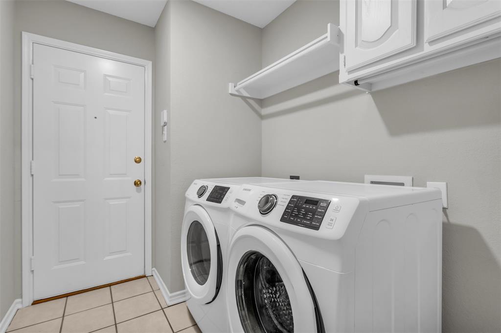 308 Glen Ridge Drive Murphy, TX 75094 - Photo 17 of 36 a view of washer and dryer with kitchen in the background
