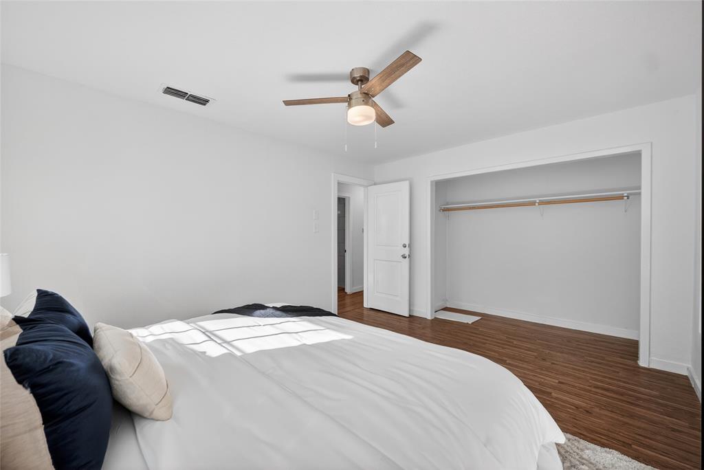 3417 Haltom Road Haltom City, TX 76117 - Photo 18 of 31 a bedroom with a bed and a ceiling fan