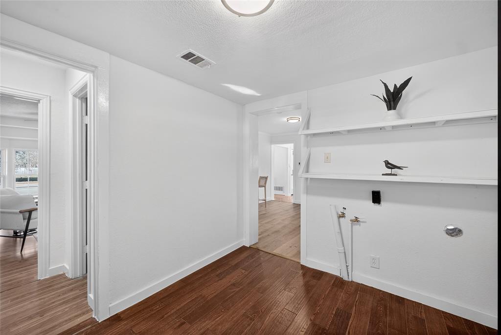 3417 Haltom Road Haltom City, TX 76117 - Photo 19 of 31 a view of a hallway with wooden floor