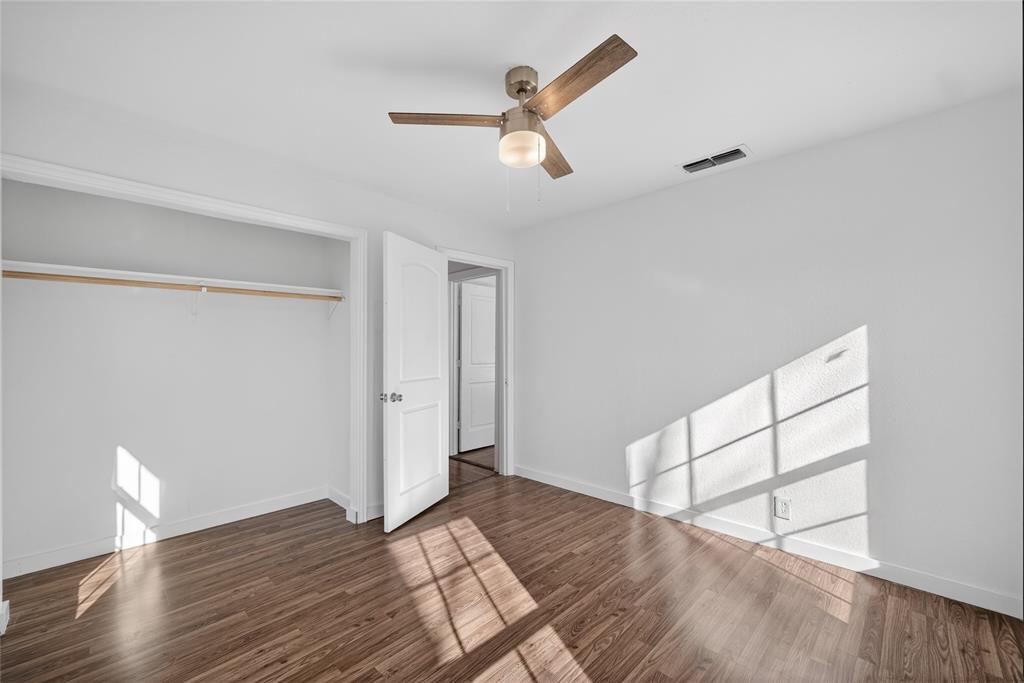 3417 Haltom Road Haltom City, TX 76117 - Photo 22 of 31 a view of empty room with wooden floor and fan