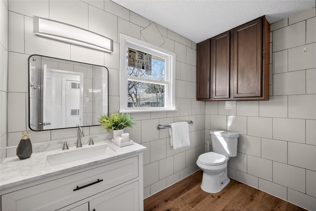 3417 Haltom Road Haltom City, TX 76117 - Photo 23 of 31 a bathroom with a toilet sink and mirror