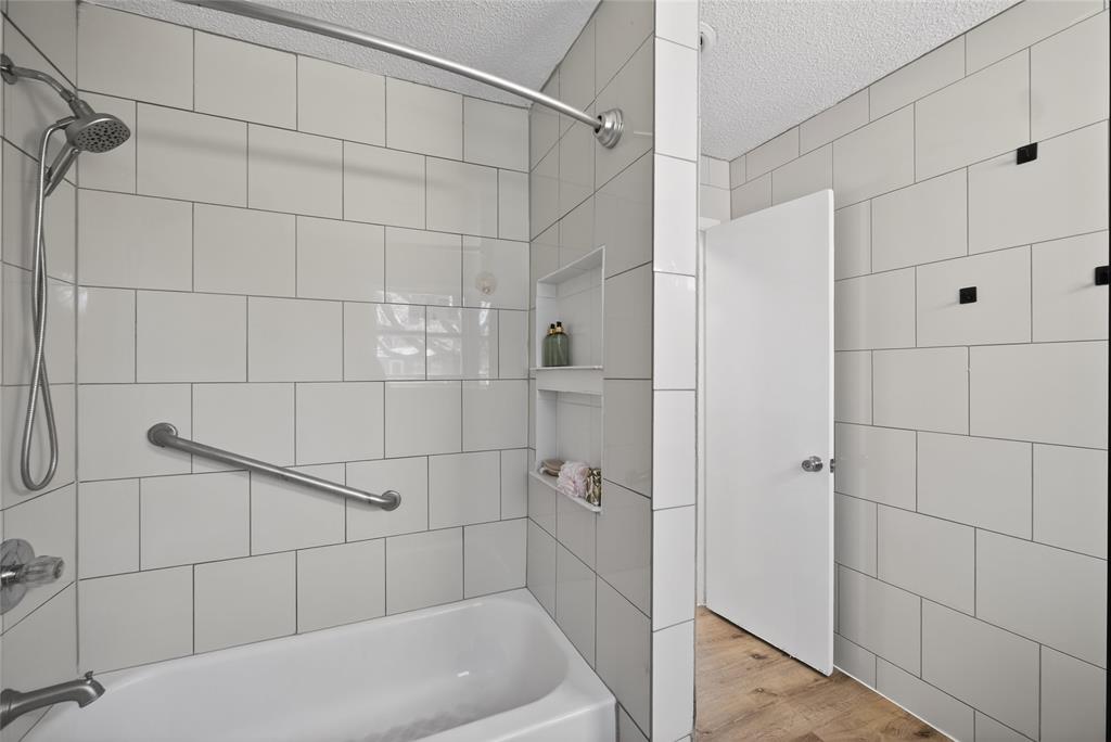 3417 Haltom Road Haltom City, TX 76117 - Photo 24 of 31 a bathroom with a bathtub and shower