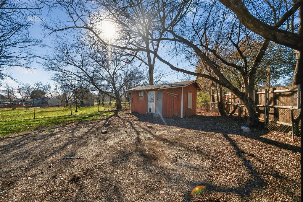 3417 Haltom Road Haltom City, TX 76117 - Photo 30 of 31 a view of a house with a yard covered in the forest