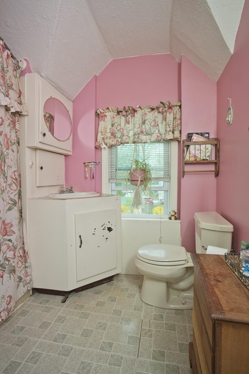 27 Governor Street Springfield, MA 01104 - Photo 11 of 18 a bathroom with a granite countertop toilet sink and mirror
