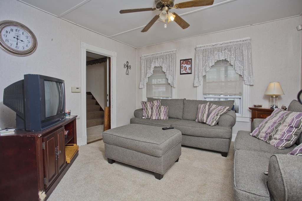 27 Governor Street Springfield, MA 01104 - Photo 3 of 18 a living room with furniture and a flat screen tv