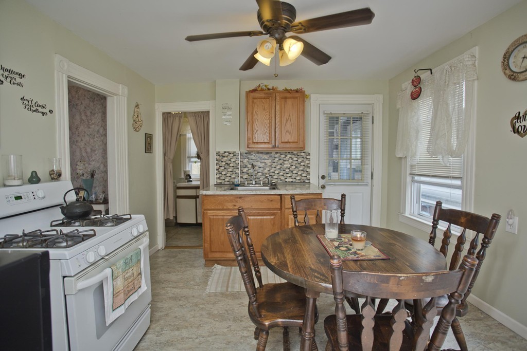 27 Governor Street Springfield, MA 01104 - Photo 6 of 18 a view of a dining room with furniture and a chandelier fan