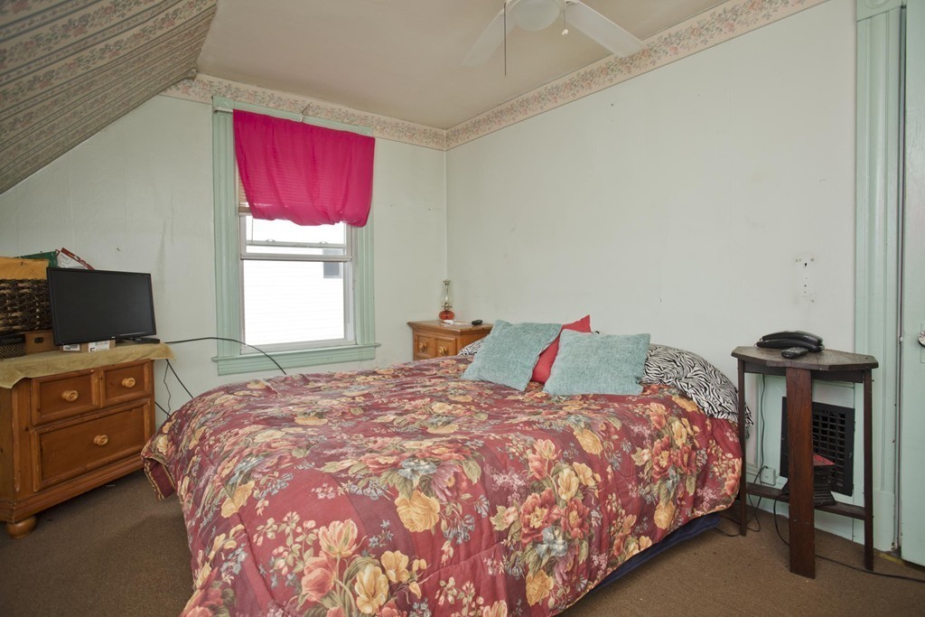 27 Governor Street Springfield, MA 01104 - Photo 8 of 18 a bedroom with a bed and a television
