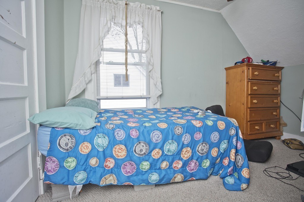 27 Governor Street Springfield, MA 01104 - Photo 10 of 18 a bedroom with a bed and a dresser