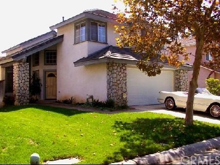 6716 Hunt Court Riverside, CA 92506 - Photo 1 of 1 a front view of a house with a garden and yard