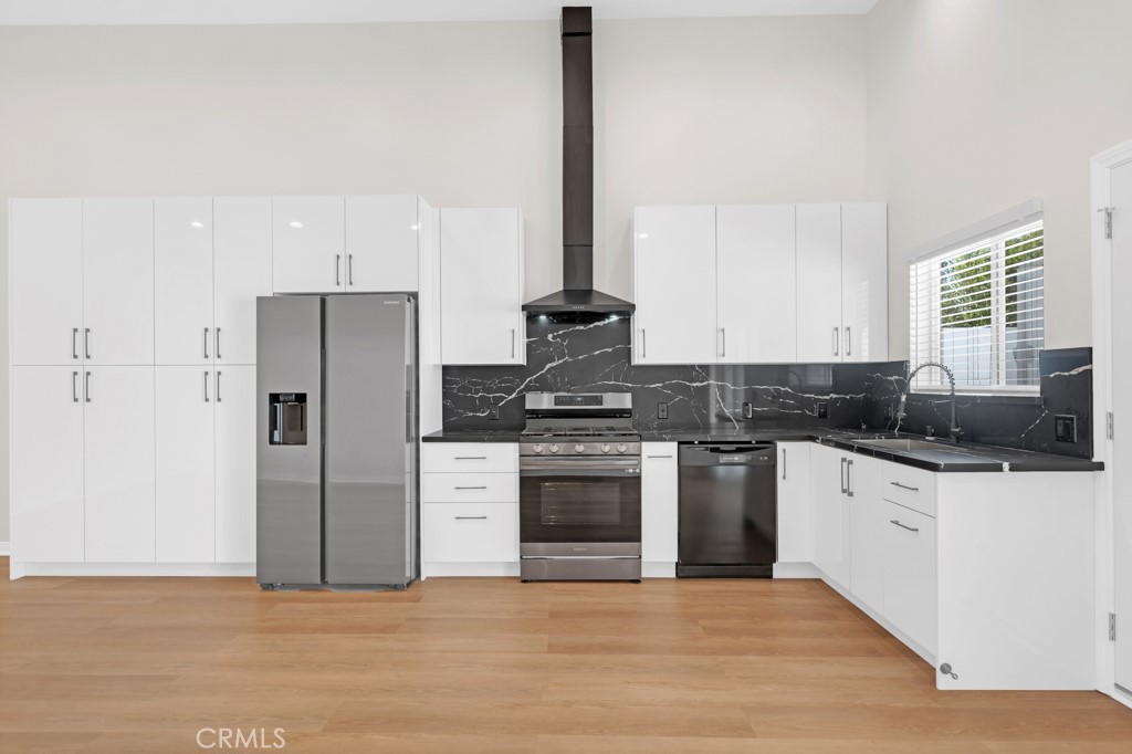 19104 Blackhawk Street Porter Ranch, CA 91326 - Photo 11 of 30 a kitchen with stainless steel appliances granite countertop a stove and a refrigerator