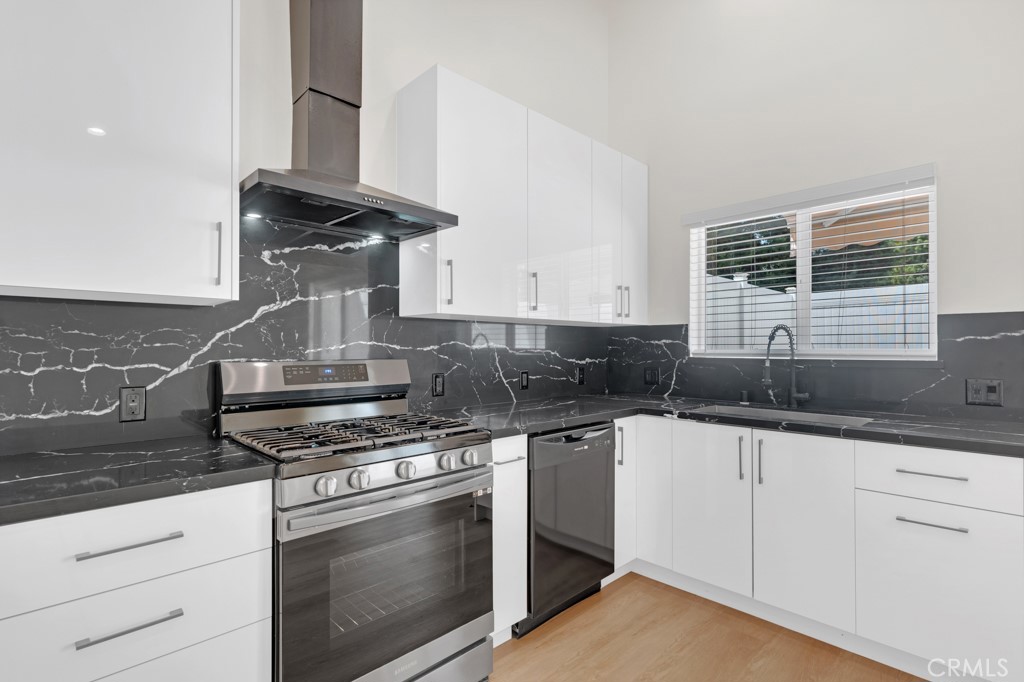 19104 Blackhawk Street Porter Ranch, CA 91326 - Photo 12 of 30 a kitchen with granite countertop a stove and a sink
