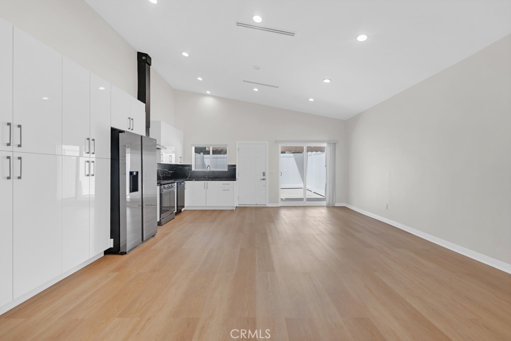 19104 Blackhawk Street Porter Ranch, CA 91326 - Photo 14 of 30 a view of a kitchen with refrigerator and wooden floor