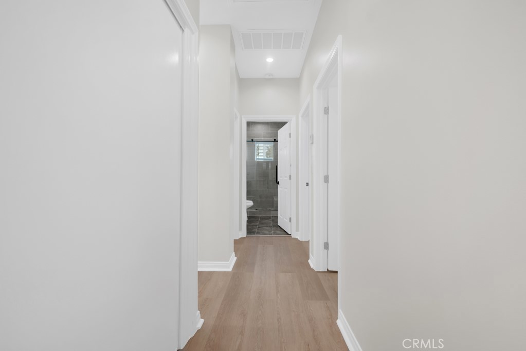 19104 Blackhawk Street Porter Ranch, CA 91326 - Photo 18 of 30 a view of a hallway with wooden floor