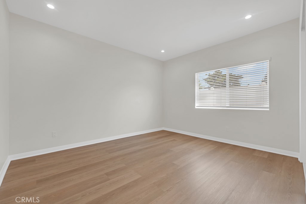 19104 Blackhawk Street Porter Ranch, CA 91326 - Photo 25 of 30 an empty room with wooden floor and windows