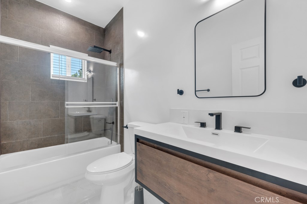 19104 Blackhawk Street Porter Ranch, CA 91326 - Photo 28 of 30 a bathroom with a sink a toilet and shower