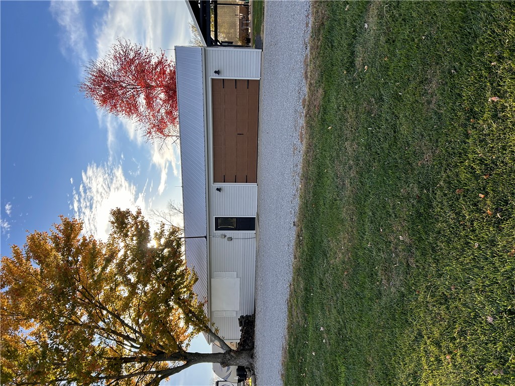 2086 Scheyhing Road Lewisburg, OH 45338 - Photo 5 of 29 This structure features a robust metal roof, an attached garage, and a welcoming side entry.