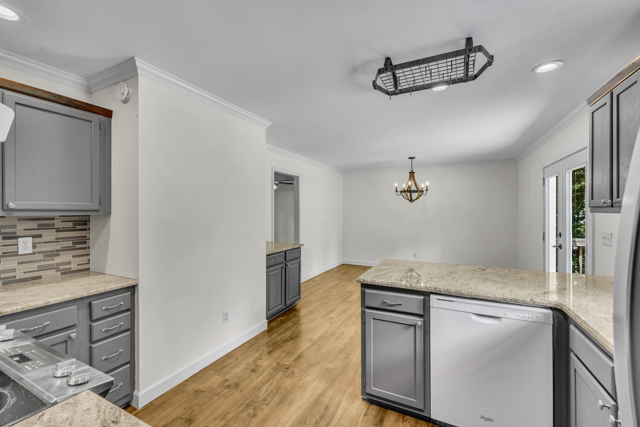 7707 Chester Road Fairview, TN 37062 - Photo 11 of 26 a kitchen with stainless steel appliances granite countertop a refrigerator a stove and a sink with wooden floor