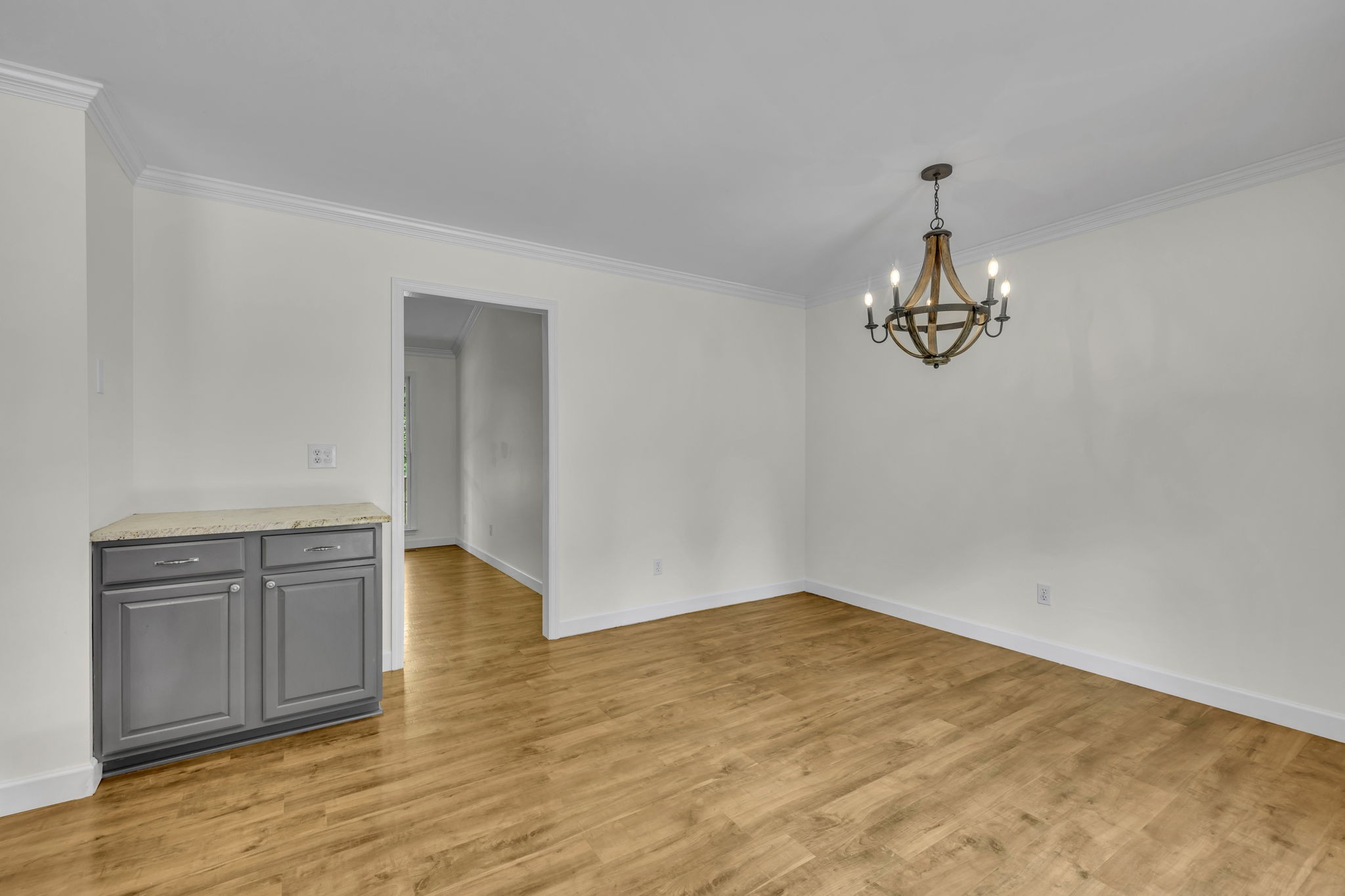 7707 Chester Road Fairview, TN 37062 - Photo 13 of 26 a view of empty room with wooden floor and kitchen
