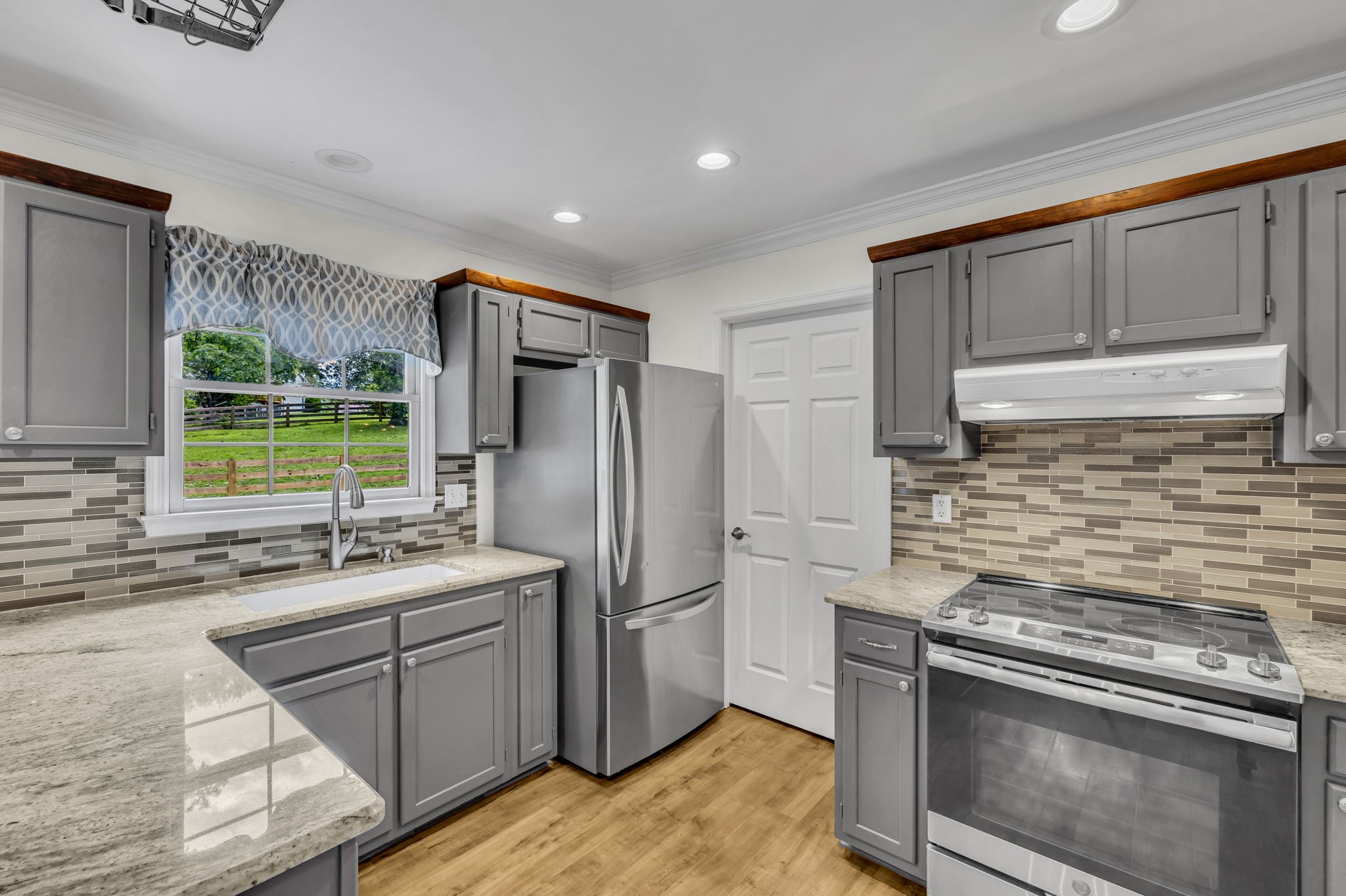 7707 Chester Road Fairview, TN 37062 - Photo 9 of 26 a kitchen with refrigerator cabinets and stainless steel appliances