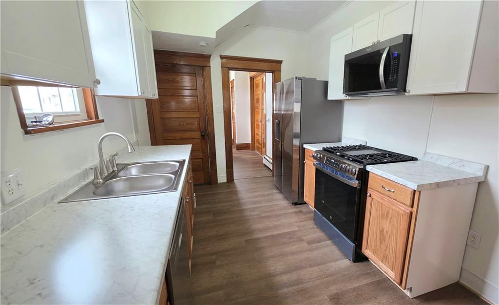422 Beaver Street Wampum, PA 16157 - Photo 11 of 30 a kitchen with stainless steel appliances granite countertop a sink stove and refrigerator