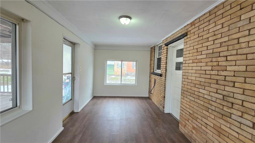 422 Beaver Street Wampum, PA 16157 - Photo 13 of 30 a view of a hallway with wooden floor and a bathroom