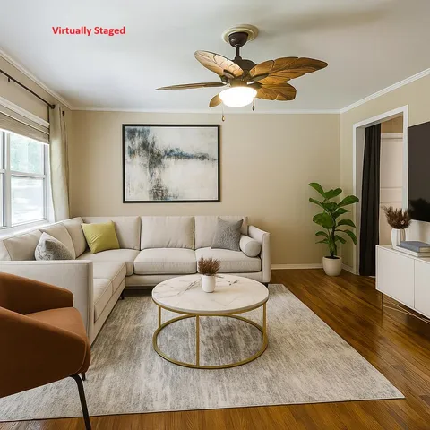 a living room with furniture and a potted plant