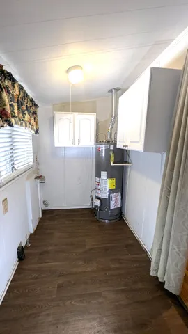 a view of a livingroom with wooden floor and a window