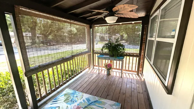 a view of a porch with wooden floor