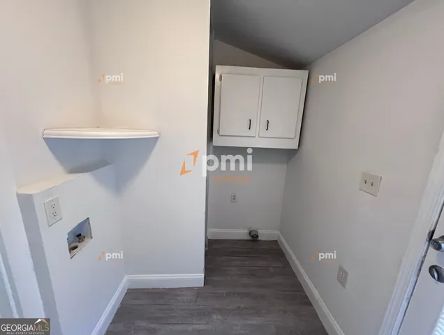 a view of a hallway with wooden floor and closet