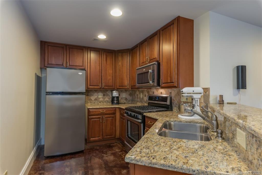 188 Timberlake Road Bostic, NC 28018 - Photo 42 of 48 a kitchen with granite countertop stainless steel appliances a refrigerator stove top oven and sink