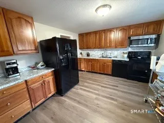 a kitchen with stainless steel appliances granite countertop a refrigerator stove and sink