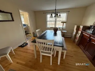 a view of a dining room with furniture window and wooden floor
