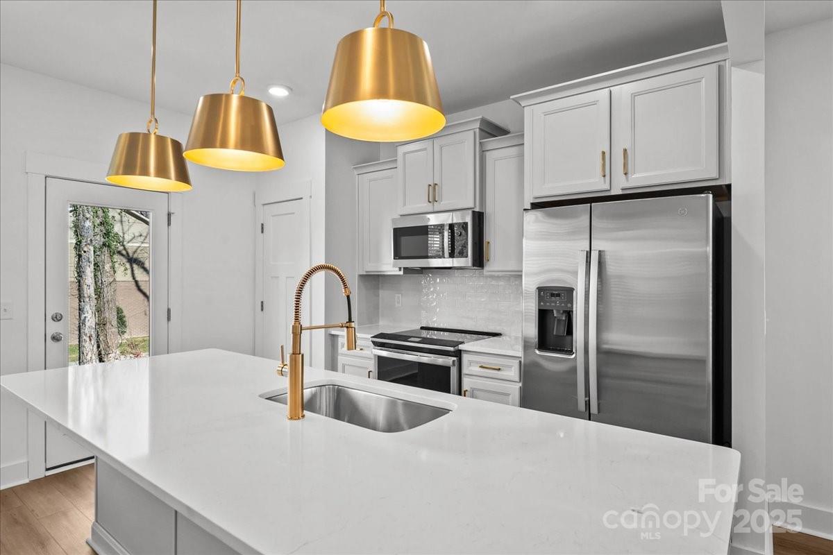 45 Moon Hvn Way Arden, NC 28704 - Photo 4 of 31 a kitchen with stainless steel appliances granite countertop a refrigerator and a stove top oven