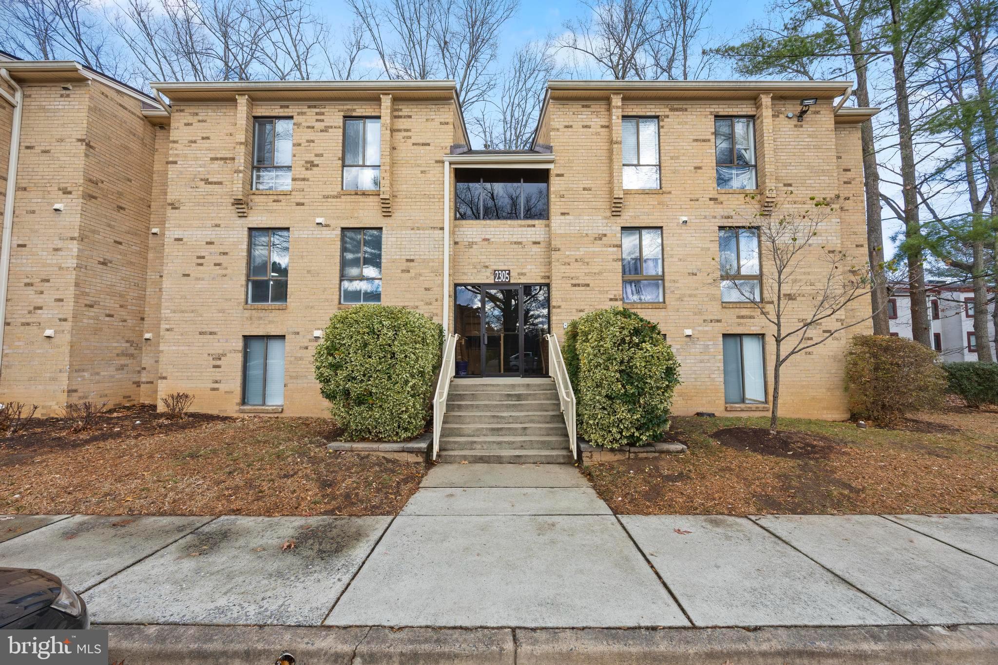 front view of a brick house with many windows