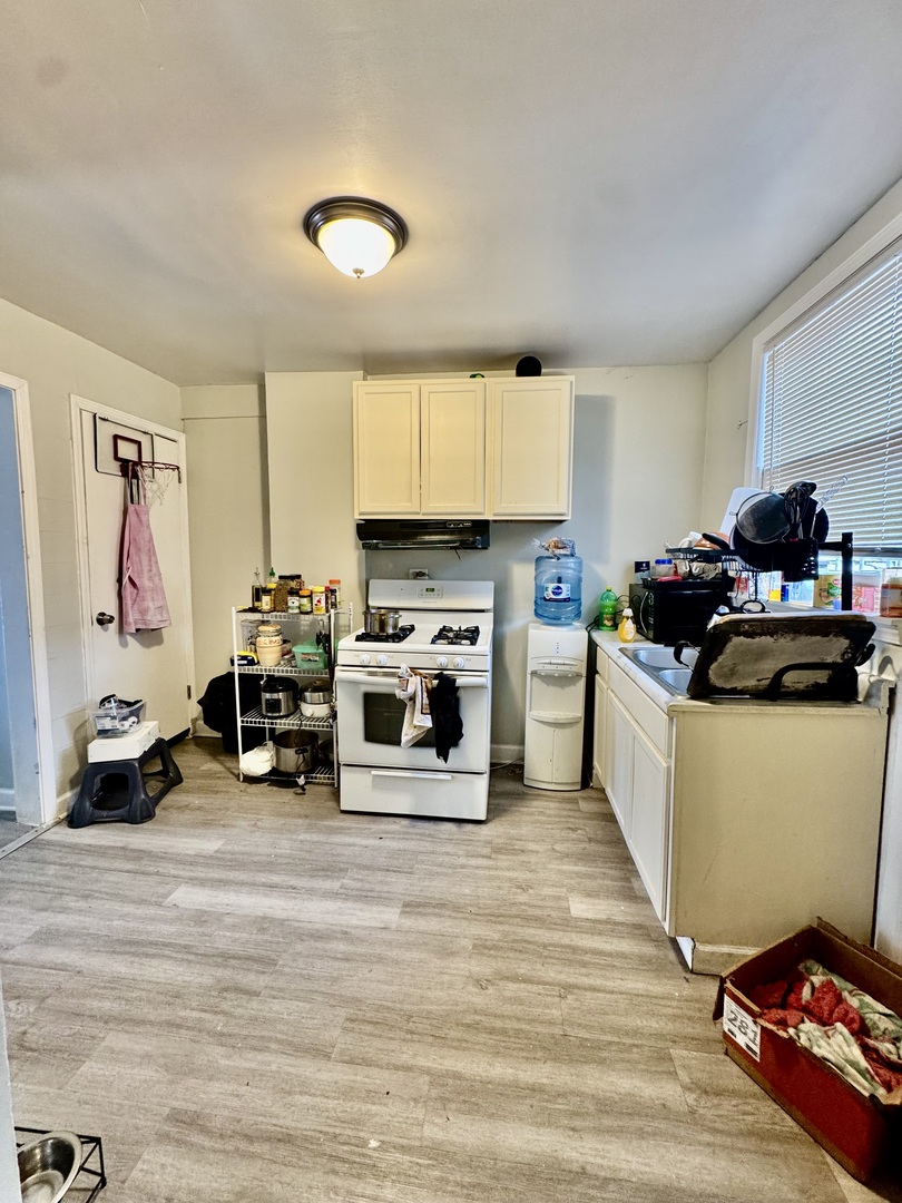 11345 South Ada Street Chicago, IL 60643 - Photo 4 of 15 a kitchen with a refrigerator and a stove top oven