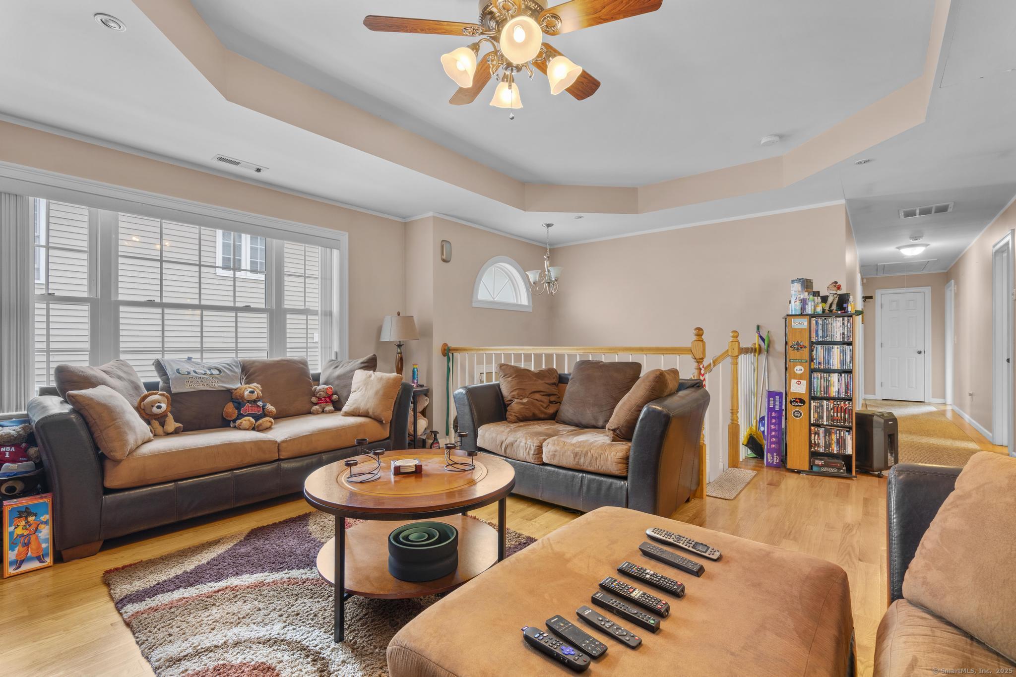 55 Allen Street New Britain, CT 06053 - Photo 20 of 40 a living room with furniture a rug and a chandelier