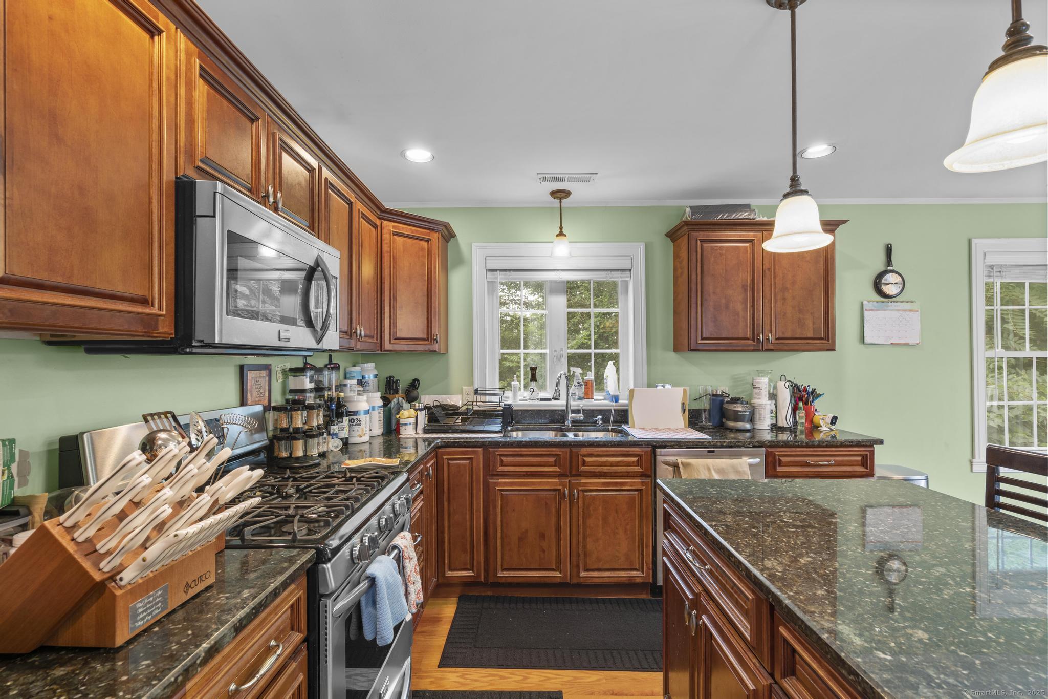 55 Allen Street New Britain, CT 06053 - Photo 26 of 40 a kitchen with stainless steel appliances granite countertop a sink stove and cabinets