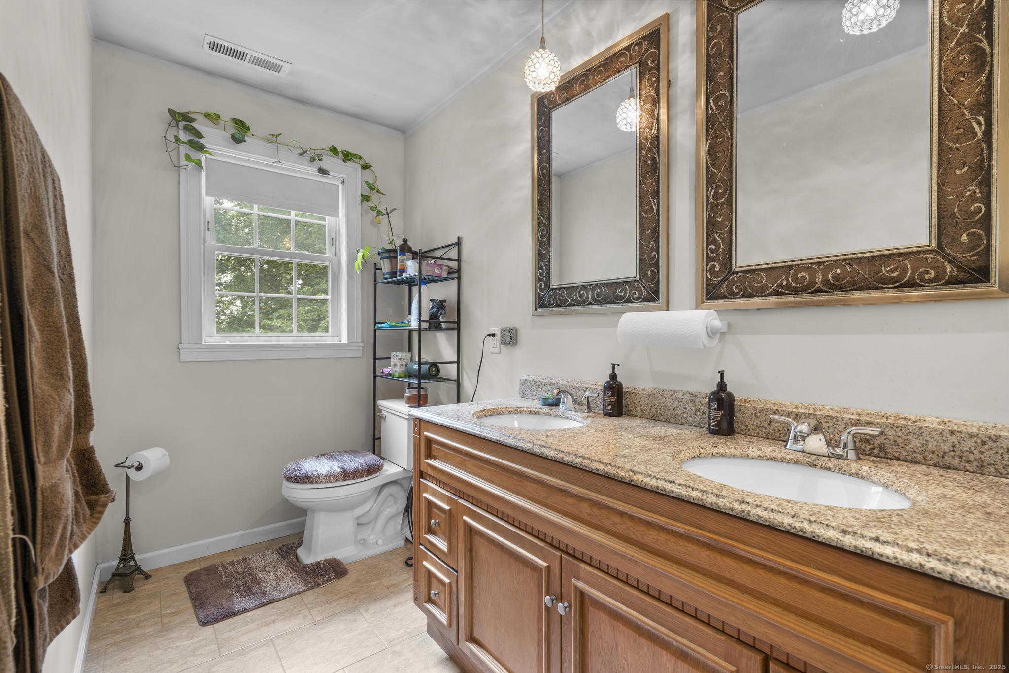 55 Allen Street New Britain, CT 06053 - Photo 31 of 40 a bathroom with a granite countertop toilet sink and mirror
