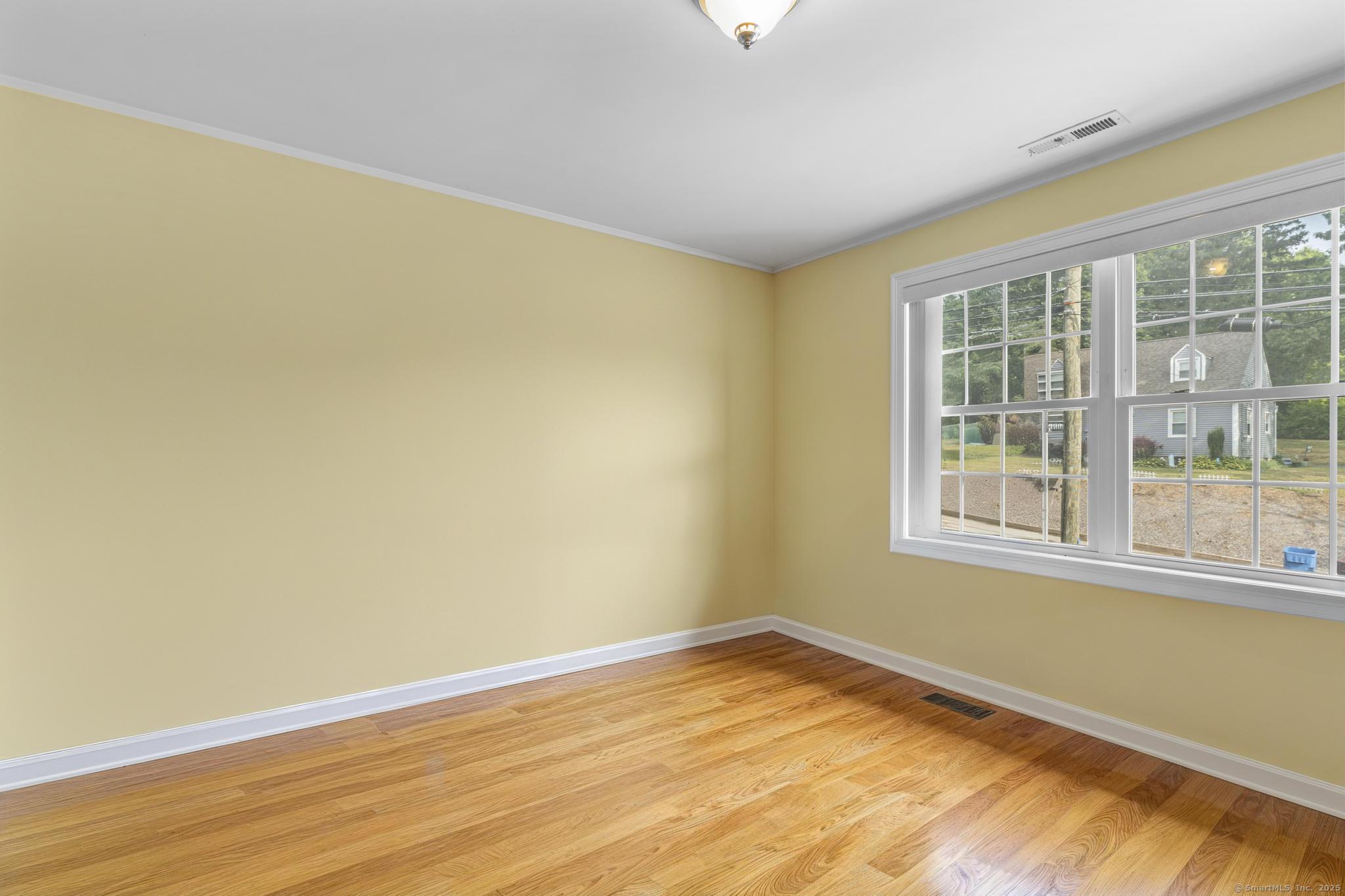 55 Allen Street New Britain, CT 06053 - Photo 34 of 40 a view of empty room with wooden floor and fan