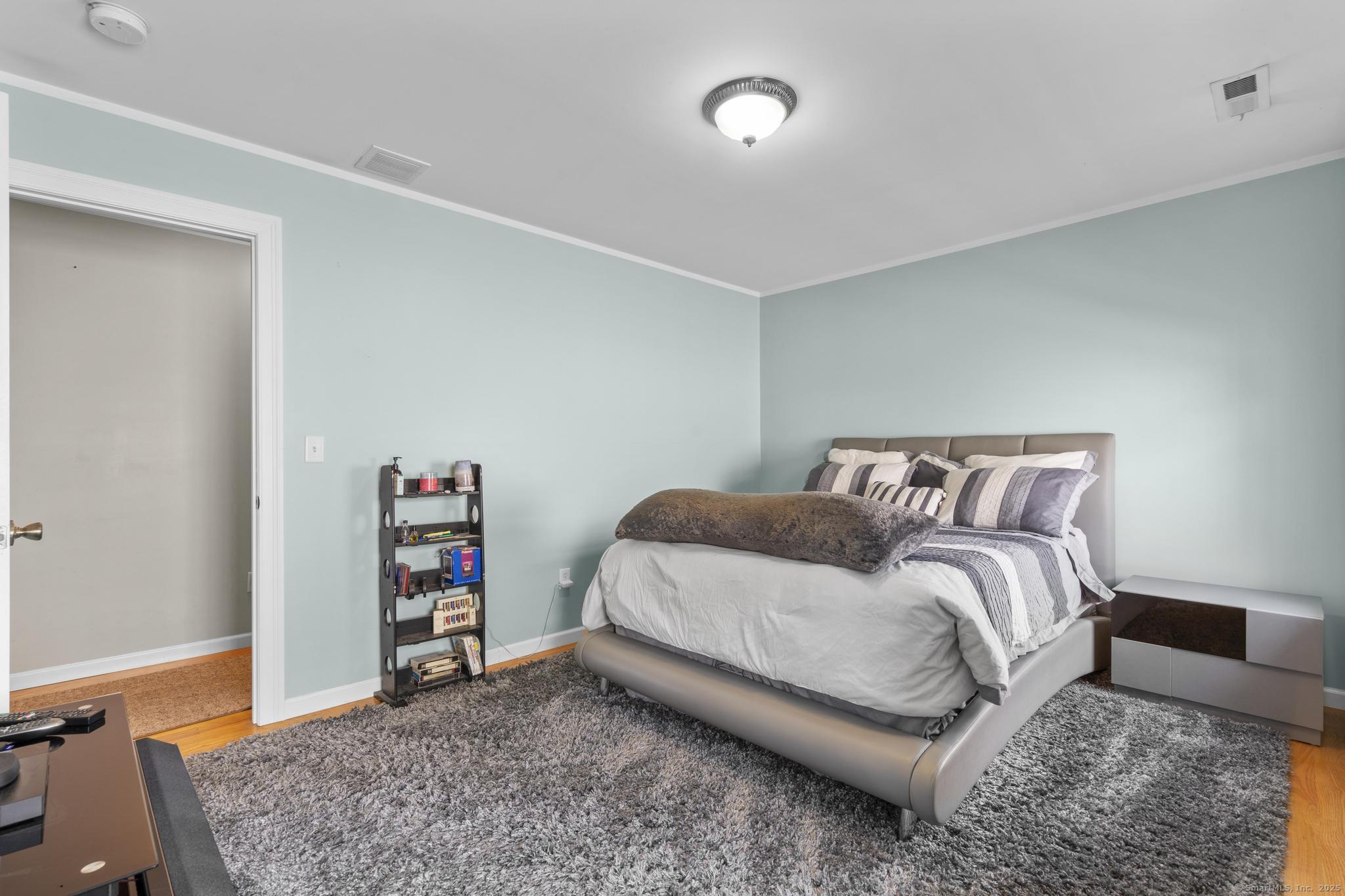 55 Allen Street New Britain, CT 06053 - Photo 35 of 40 a bedroom with a bed and a book shelf