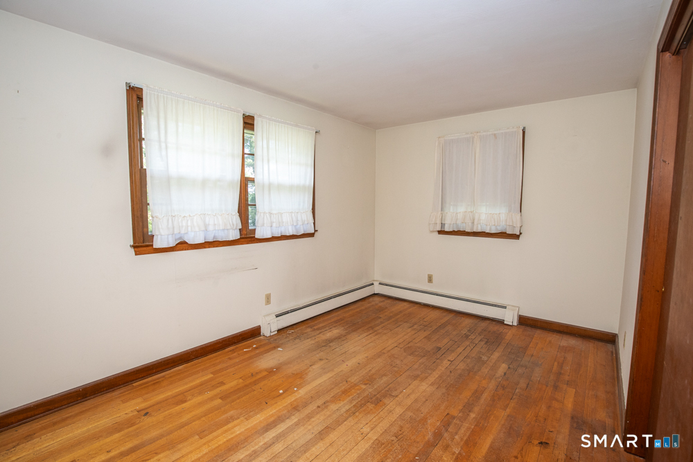 64 Somer Drive Meriden, CT 06451 - Photo 17 of 28 an empty room with wooden floor and windows