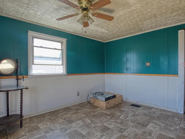 a view of a garage with an empty space and a car parked