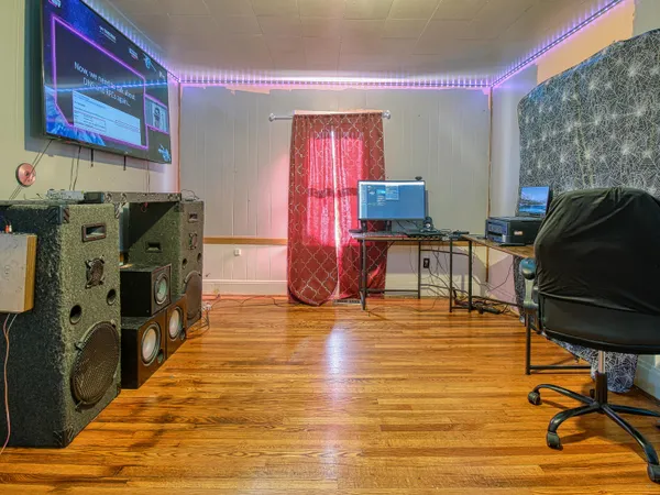 a living room with furniture and a wooden floor